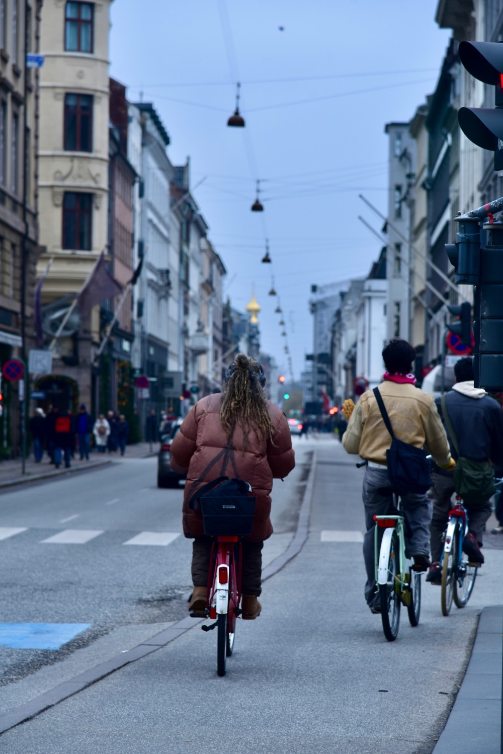 Cyclists riding single file in a Copenhagen bike lane